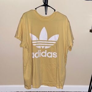Pastel yellow Adidas t-shirt.